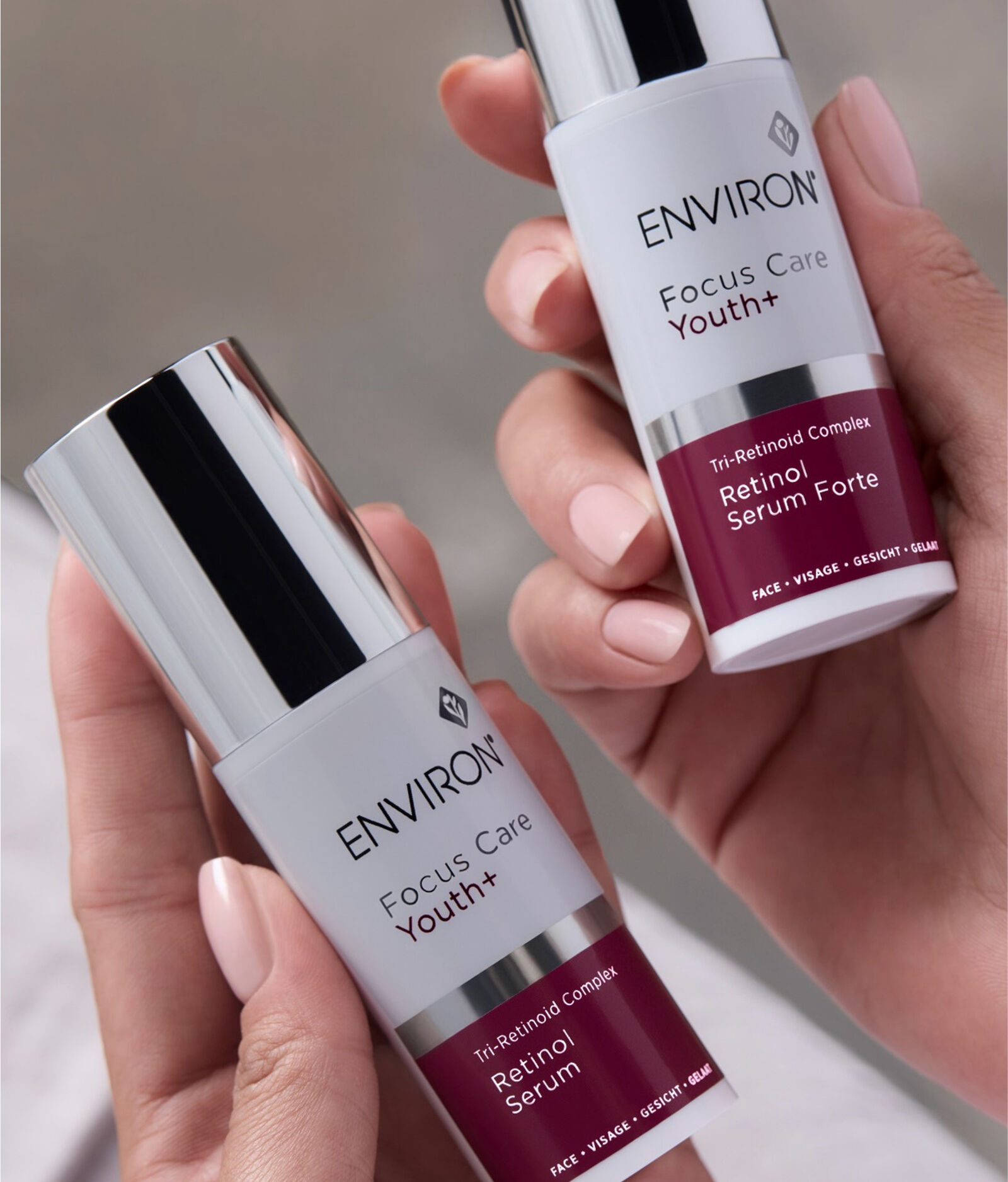Hands holding Environ Focus Care Youth+ Retinol Serum and Retinol Serum Forte