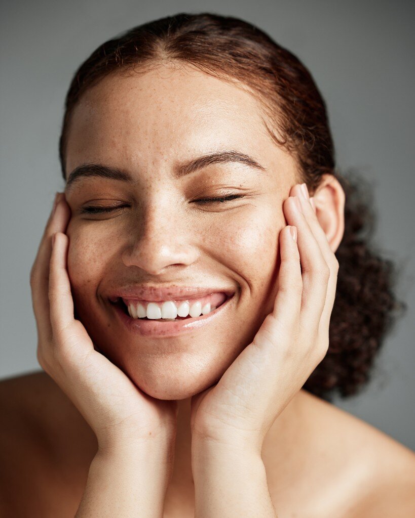 Woman smiling with healthy glowing skin